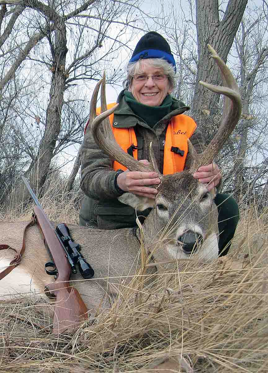 Some hunters claim the .243 Winchester is inefficient for big northern whitetails. Eileen Clarke used a .243 to drop her bigest-bodied buck instantly by putting a 100-grain Nosler Partition through the shoulders and spine.